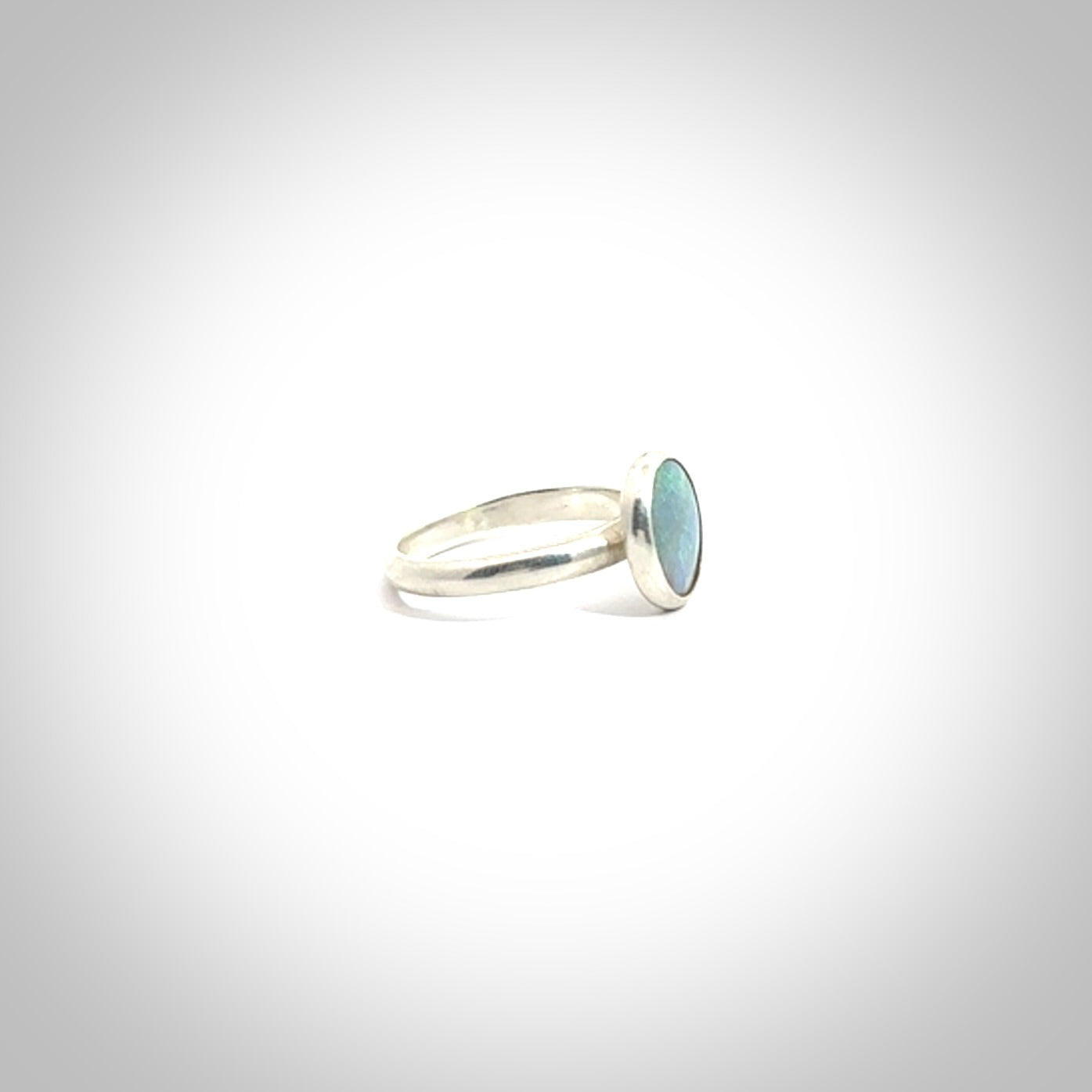 This is a handcrafted real opal ring with sterling silver. The colours are a gorgeous turquoise blue. This is a solid little work of art. We ship this worldwide for free and are happy to answer any questions that you may have about these or other products on our website.