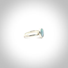 This is a handcrafted real opal ring with sterling silver. The colours are a gorgeous turquoise blue. This is a solid little work of art. We ship this worldwide for free and are happy to answer any questions that you may have about these or other products on our website.