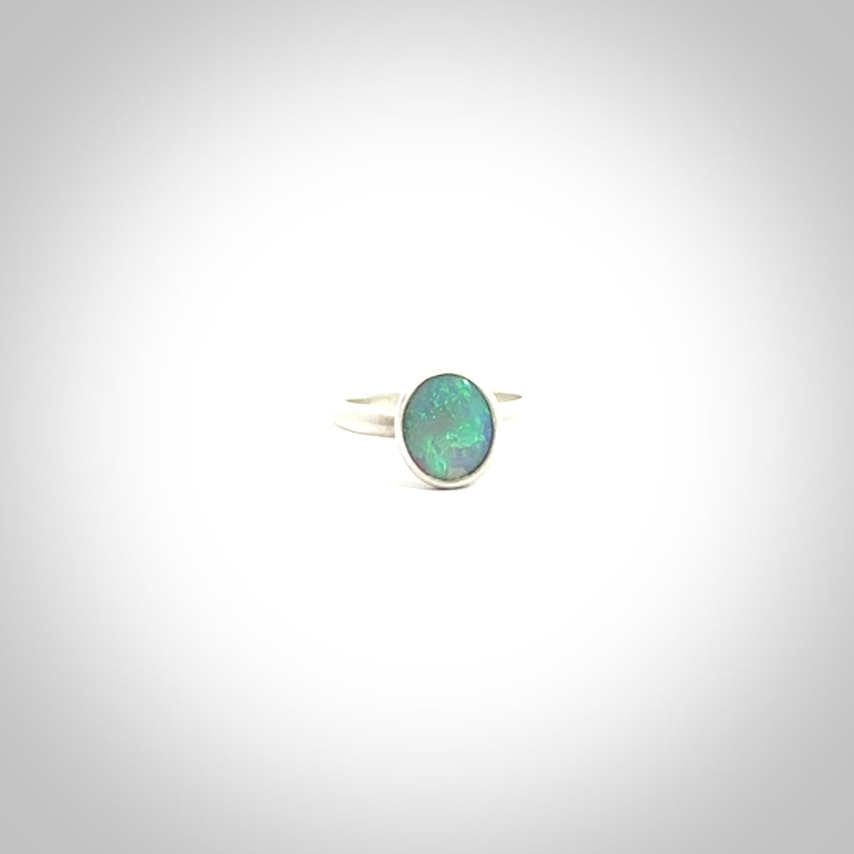 This is a handcrafted real opal ring with sterling silver. The colours are a gorgeous turquoise blue. This is a solid little work of art. We ship this worldwide for free and are happy to answer any questions that you may have about these or other products on our website.