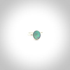 This is a handcrafted real opal ring with sterling silver. The colours are a gorgeous turquoise blue. This is a solid little work of art. We ship this worldwide for free and are happy to answer any questions that you may have about these or other products on our website.