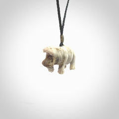 Hand carved deer antler hippo pendant. Hand carved by NZ Pacific. Free postage worldwide. Hand made hippopotamus necklace from deer antler. Animal themed necklace for men and women. Delivered on an adjustable cord in a woven kete pouch.