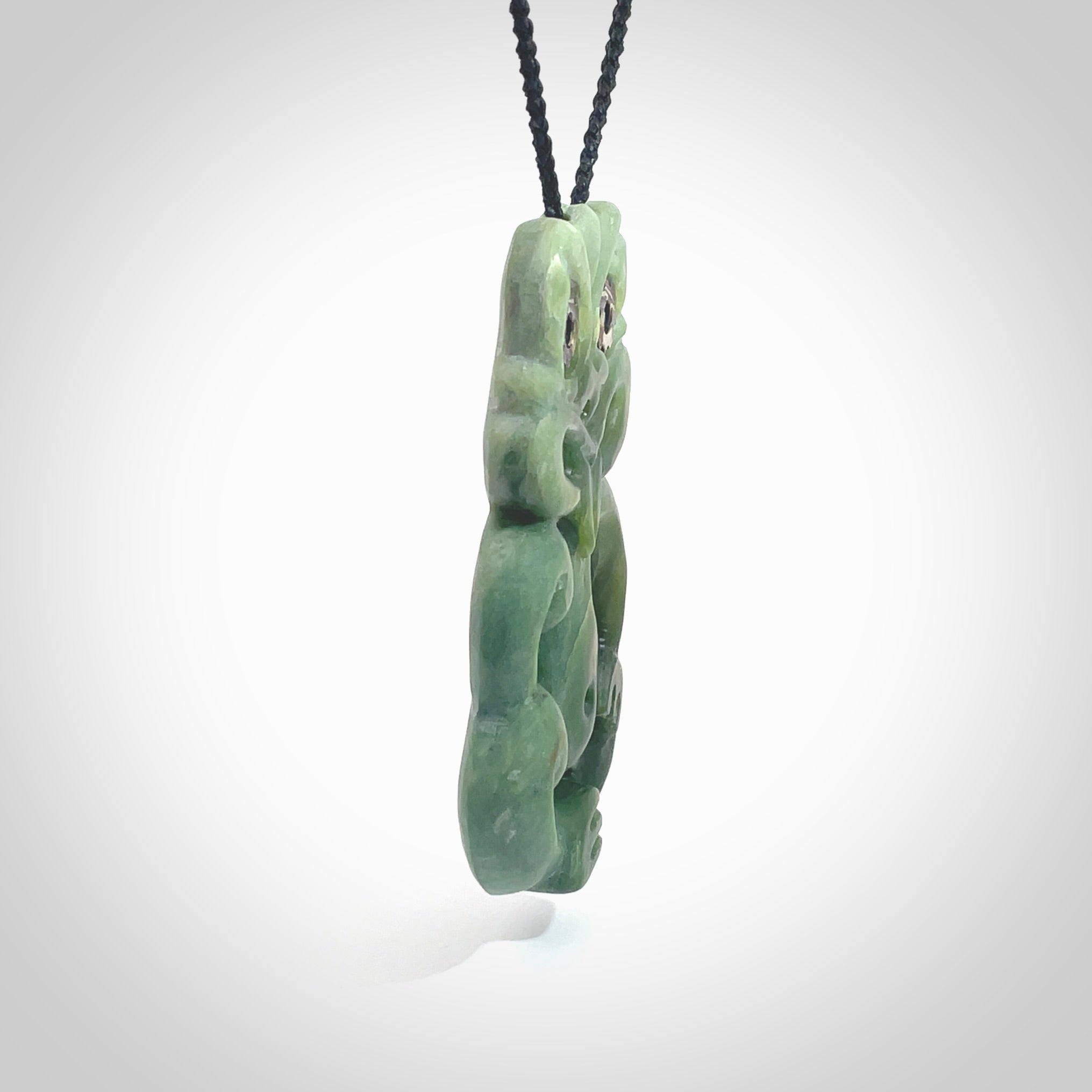 This is a large sized tiki - carved from gorgeous Marsden jade. The craftsmanship is superb, this piece is as well carved as any we have seen. The cord is an adjustable four plaited cord in black. One only by Ana Krakosky.