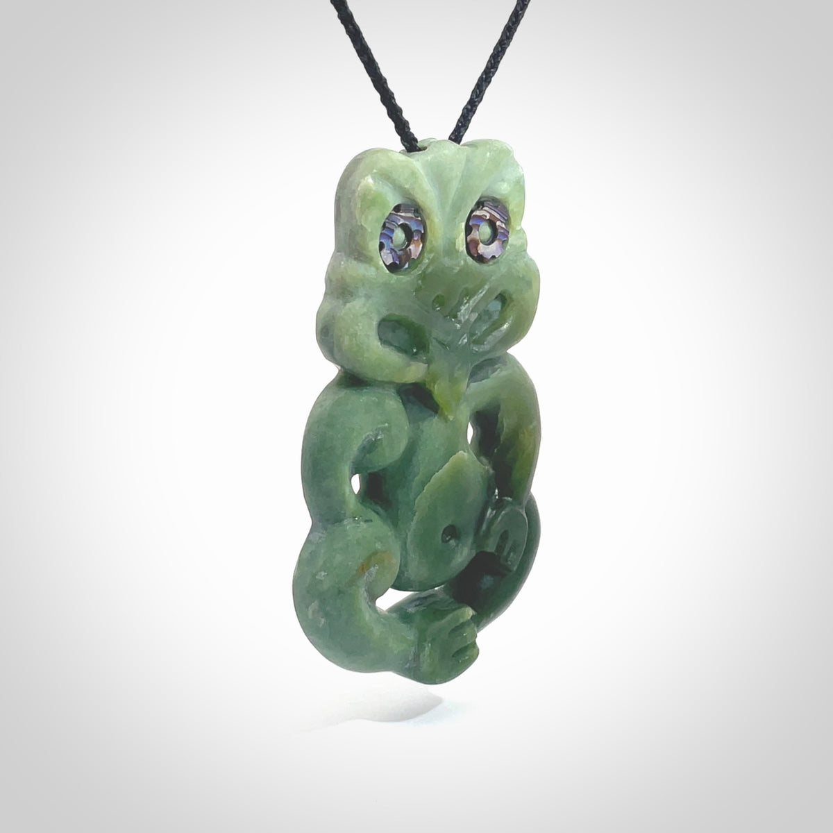 This is a large sized tiki - carved from gorgeous Marsden jade. The craftsmanship is superb, this piece is as well carved as any we have seen. The cord is an adjustable four plaited cord in black. One only by Ana Krakosky.