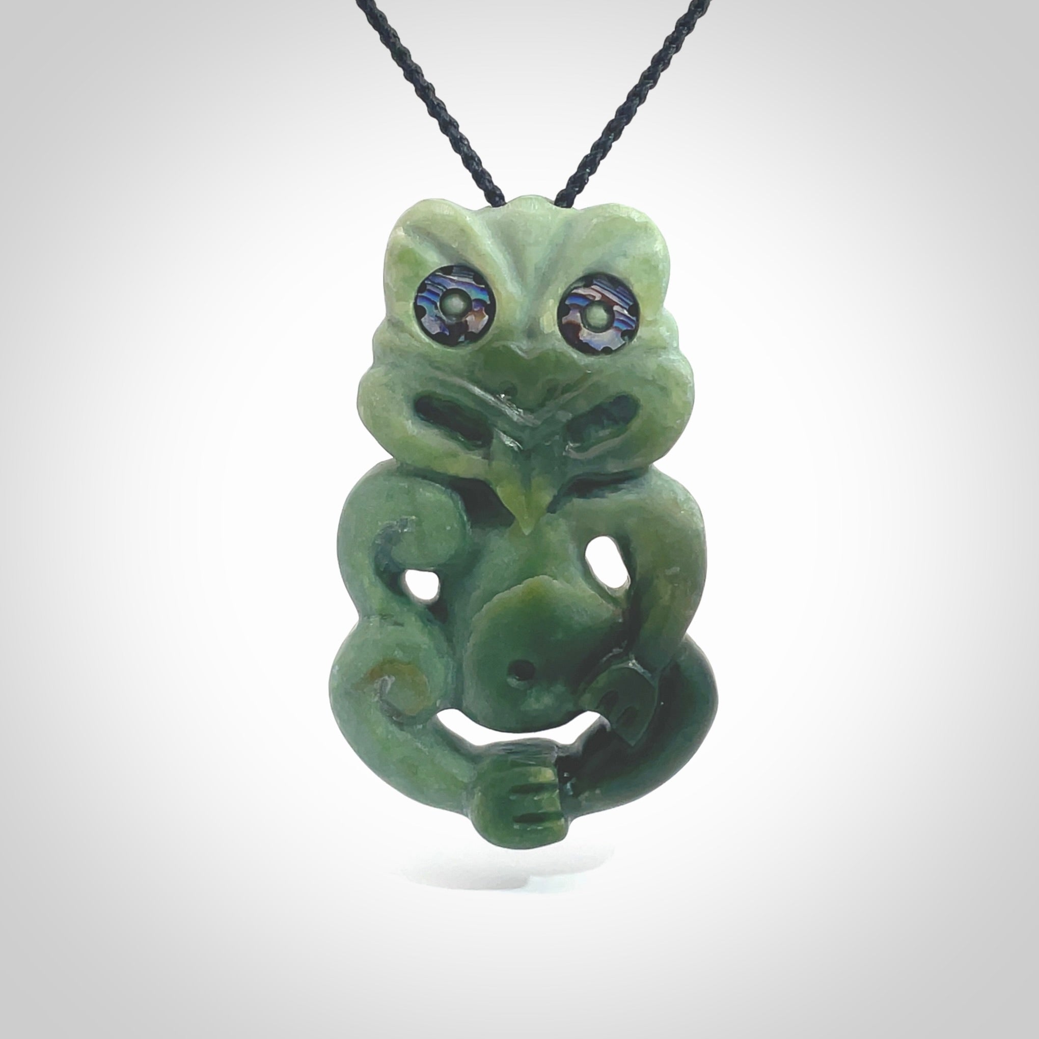 This is a large sized tiki - carved from gorgeous Marsden jade. The craftsmanship is superb, this piece is as well carved as any we have seen. The cord is an adjustable four plaited cord in black. One only by Ana Krakosky.