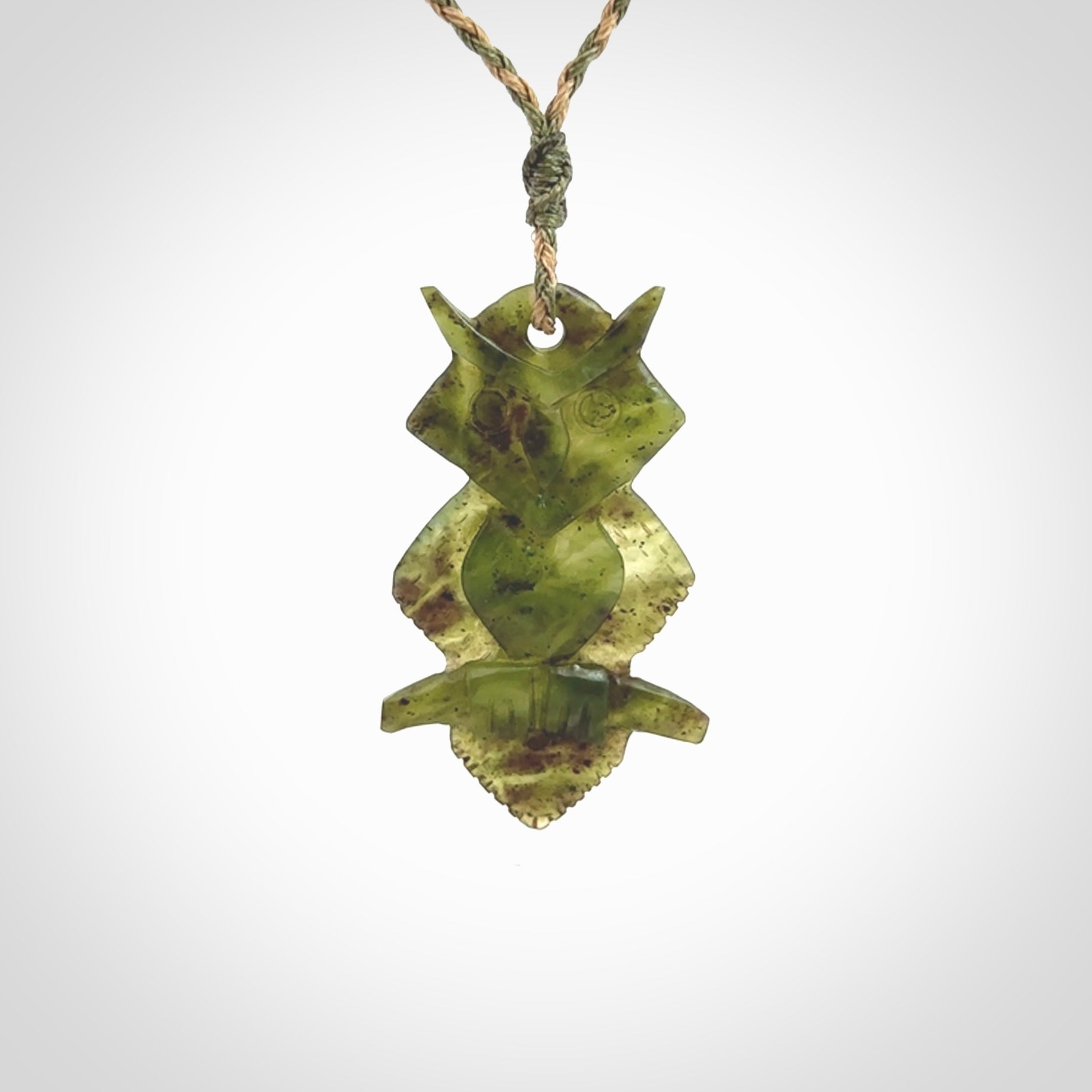 This photo shows a owl pendant carved from New Zealand Totoweka Jade. The artist, Shaun Gardiner, has carved this beautifully. We provide this piece with an adjustable green/tan cord. This is a fantastic work of art, we have one only.