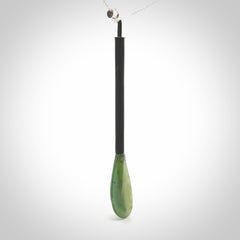 This pendant is a hand carved boat paddle. We have carved this with a Black jade blade or a green jade blade with a hardwood and sterling silver handle. Provided with a sterling silver chain.