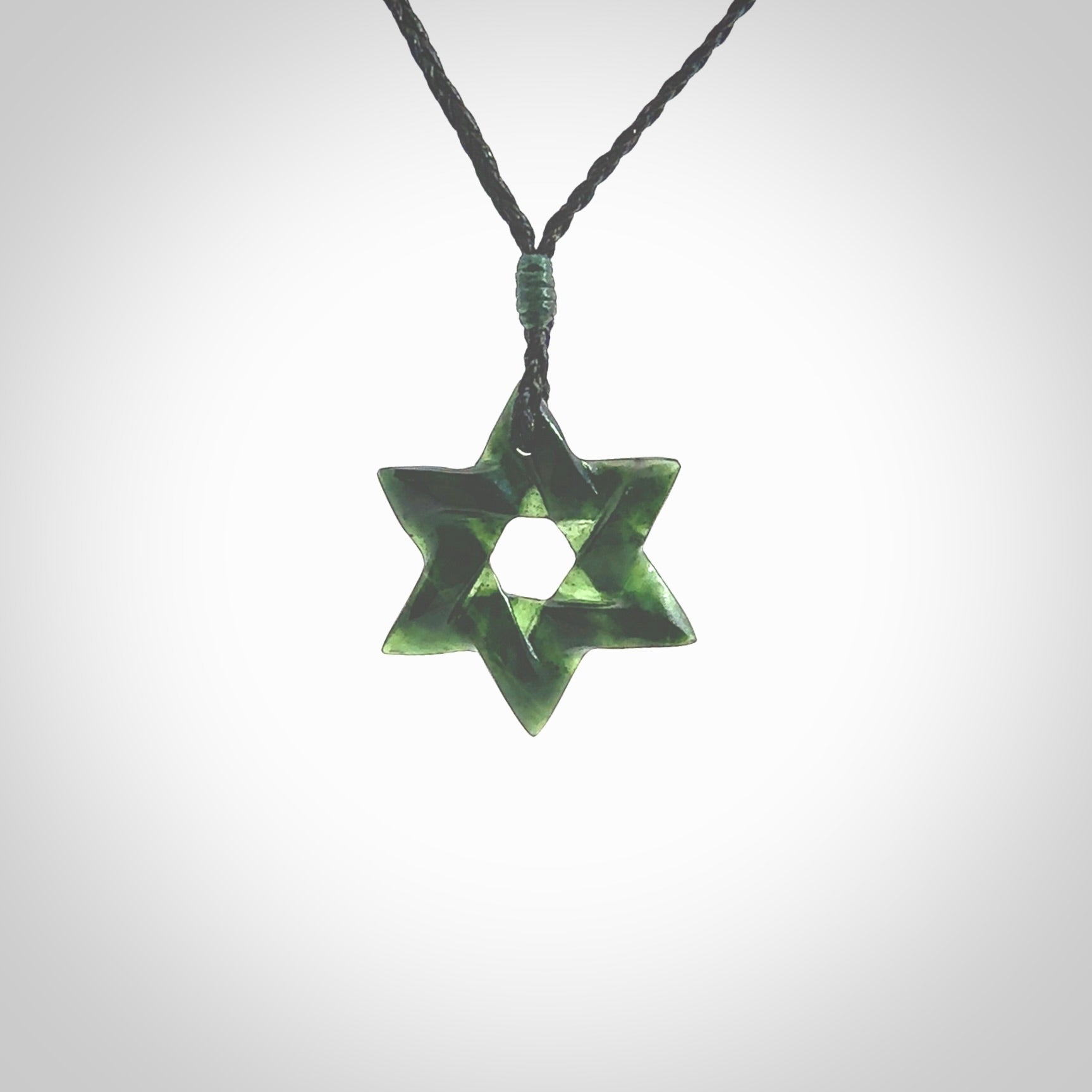 Hand carved New Zealand Tangiwai Pounamu small Magen David necklace. Unique and creative art to wear from New Zealand Tangiwai Pounamu hand made by New Zealand artist Graeme Wylie. Magen David pendant for men and women.