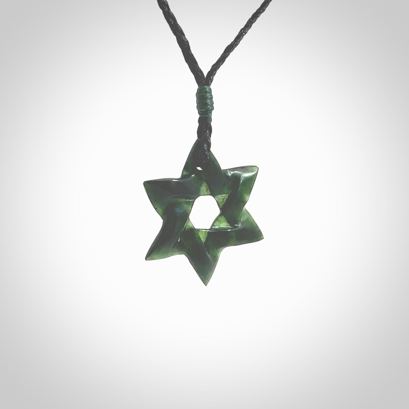 Hand carved New Zealand Tangiwai Pounamu small Magen David necklace. Unique and creative art to wear from New Zealand Tangiwai Pounamu hand made by New Zealand artist Graeme Wylie. Magen David pendant for men and women.