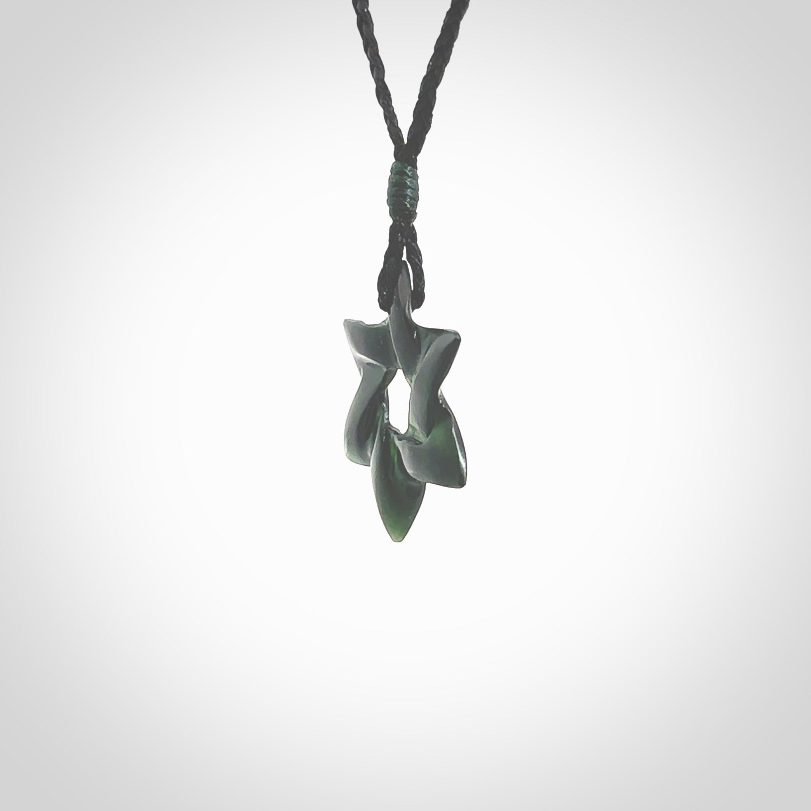 Hand carved New Zealand Tangiwai Pounamu small Magen David necklace. Unique and creative art to wear from New Zealand Tangiwai Pounamu hand made by New Zealand artist Graeme Wylie. Magen David pendant for men and women.