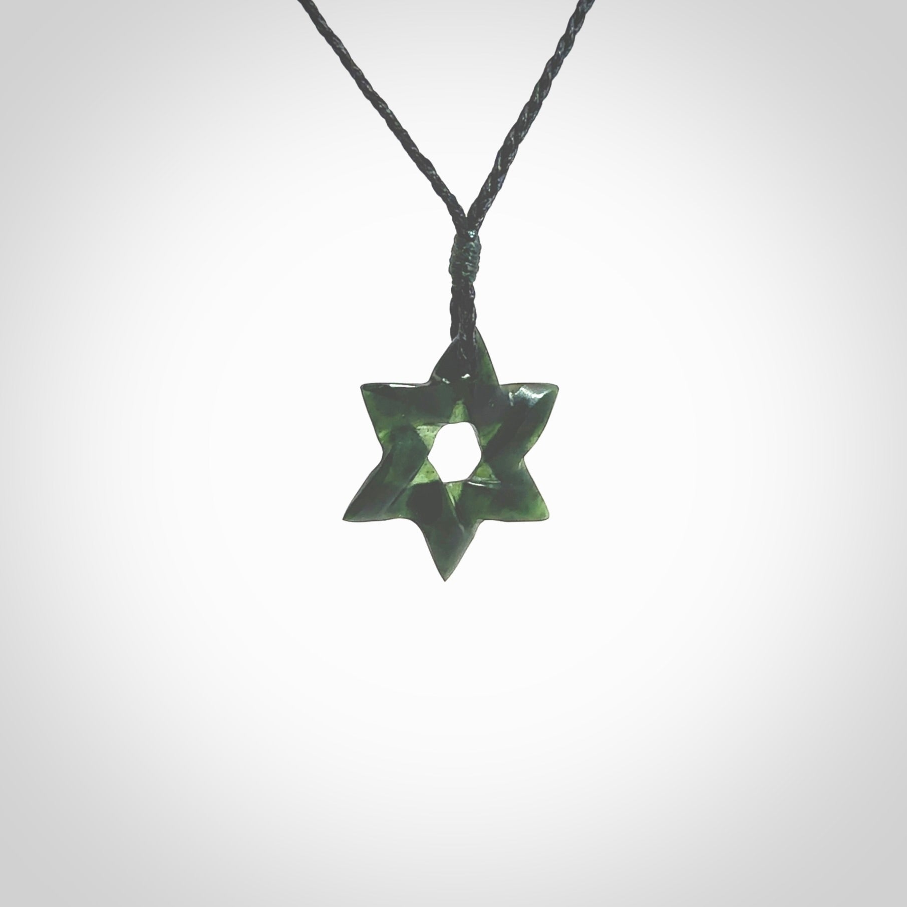 Hand carved New Zealand Tangiwai Pounamu small Magen David necklace. Unique and creative art to wear from New Zealand Tangiwai Pounamu hand made by New Zealand artist Graeme Wylie. Magen David pendant for men and women.