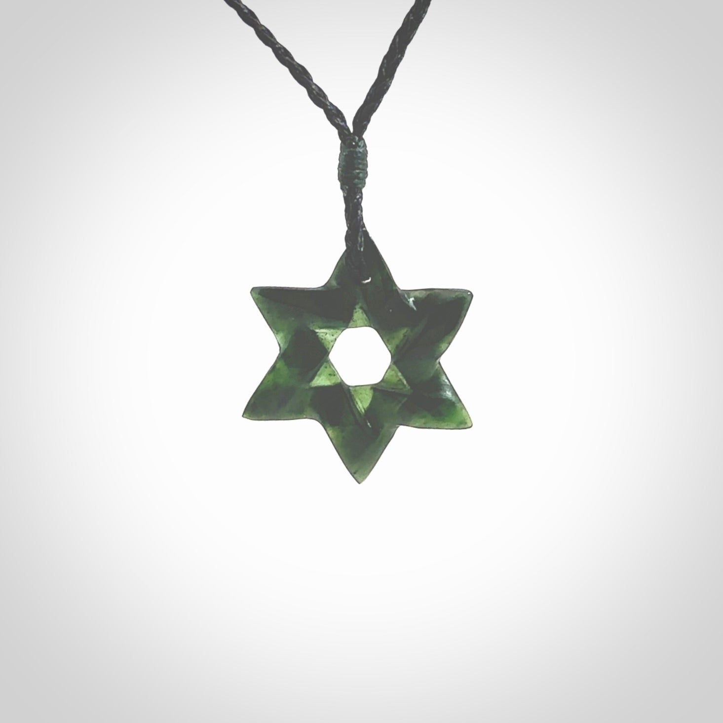 Hand carved New Zealand Tangiwai Pounamu small Magen David necklace. Unique and creative art to wear from New Zealand Tangiwai Pounamu hand made by New Zealand artist Graeme Wylie. Magen David pendant for men and women.