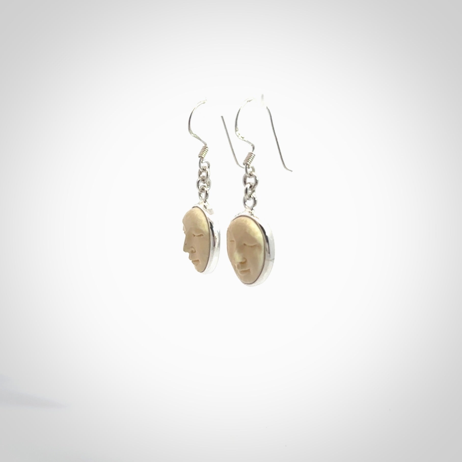 Hand made woolly mammoth tusk moon face earrings. Made by NZ Pacific and sale online only.