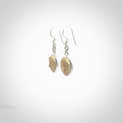 Hand made woolly mammoth tusk moon face earrings. Made by NZ Pacific and sale online only.