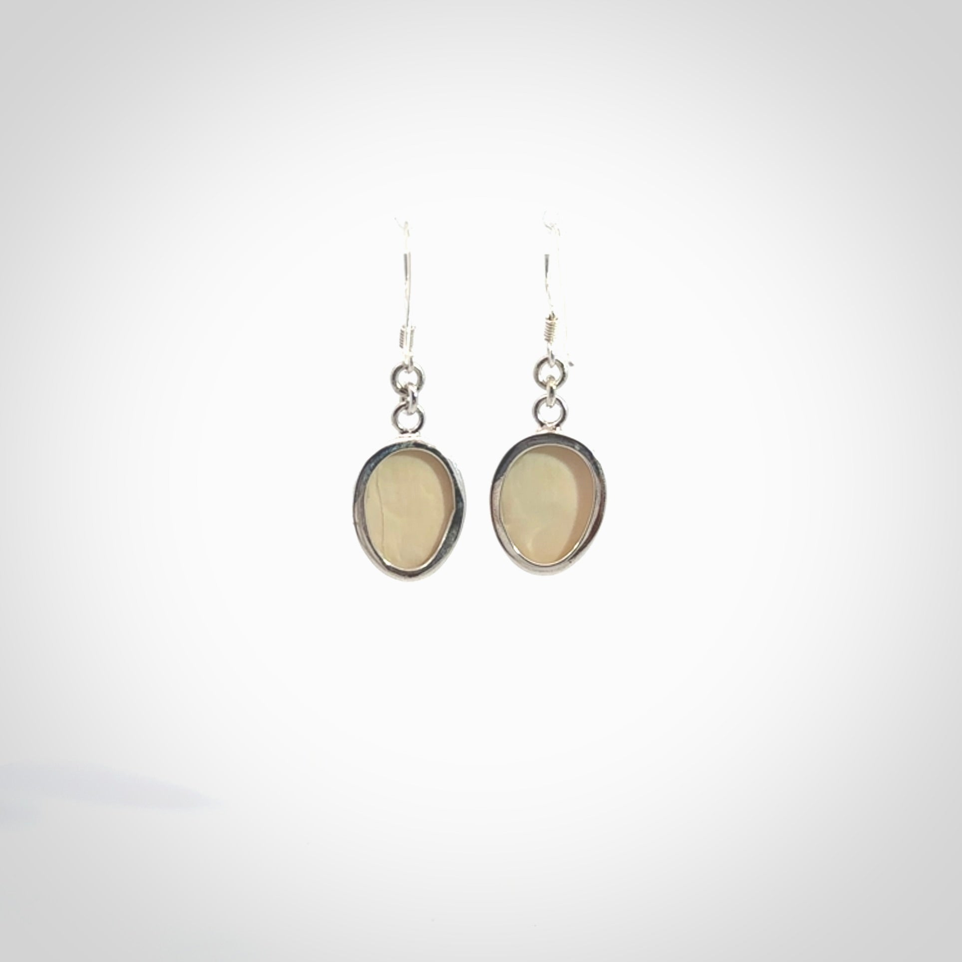 Hand made woolly mammoth tusk moon face earrings. Made by NZ Pacific and sale online only.