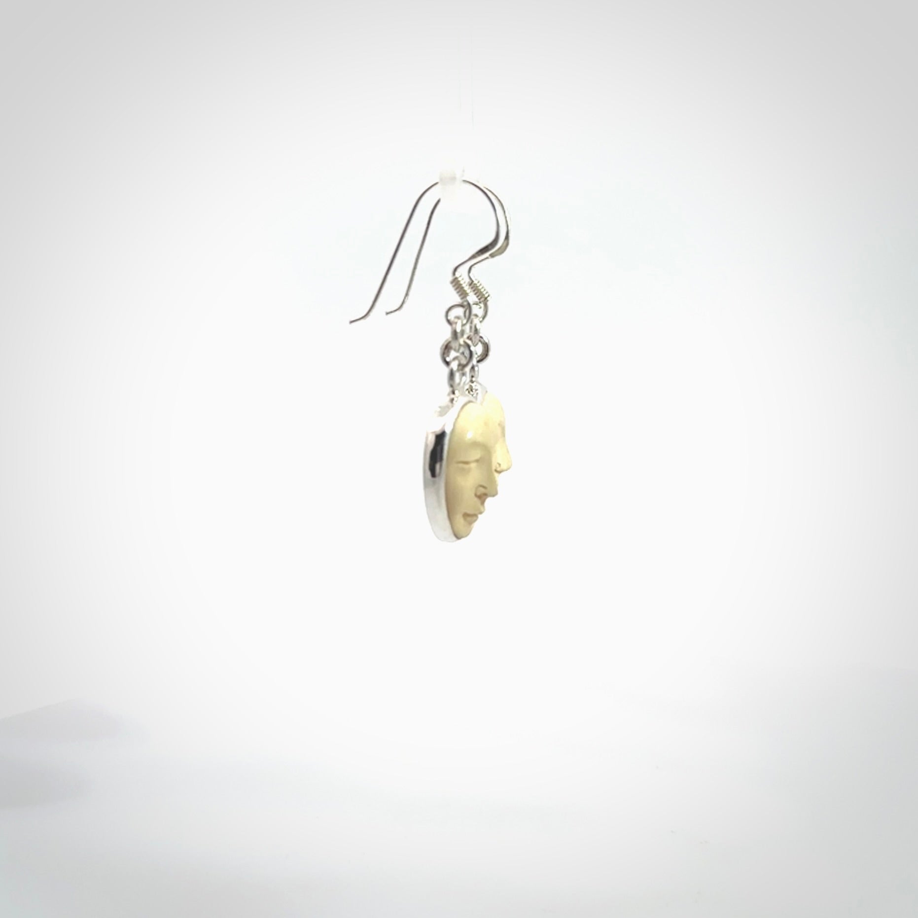 Hand made woolly mammoth tusk moon face earrings. Made by NZ Pacific and sale online only.