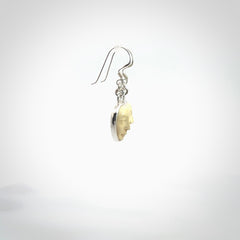 Hand made woolly mammoth tusk moon face earrings. Made by NZ Pacific and sale online only.