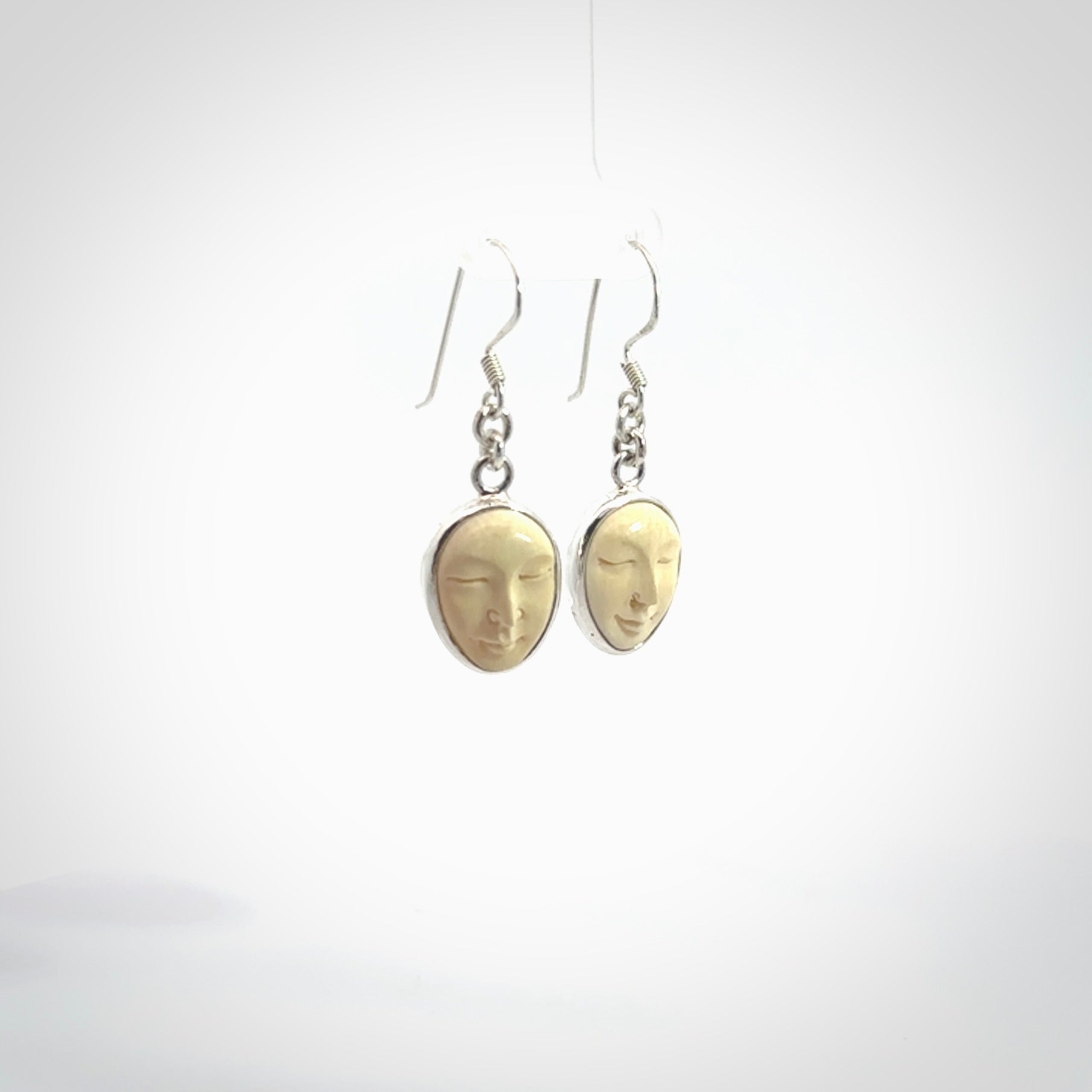 Hand made woolly mammoth tusk moon face earrings. Made by NZ Pacific and sale online only.