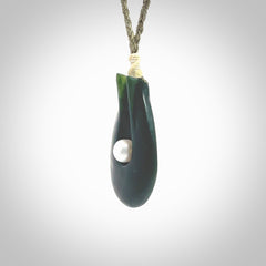 This is a unique contemporary drop pendant, hand carved from New Zealand Jade with Pearl insert. The cord is olive green and is length adjustable. This is delivered to you with Express Courier. Hand carved Pounamu, Jade necklace with adjustable cord from Ana Krakosky.