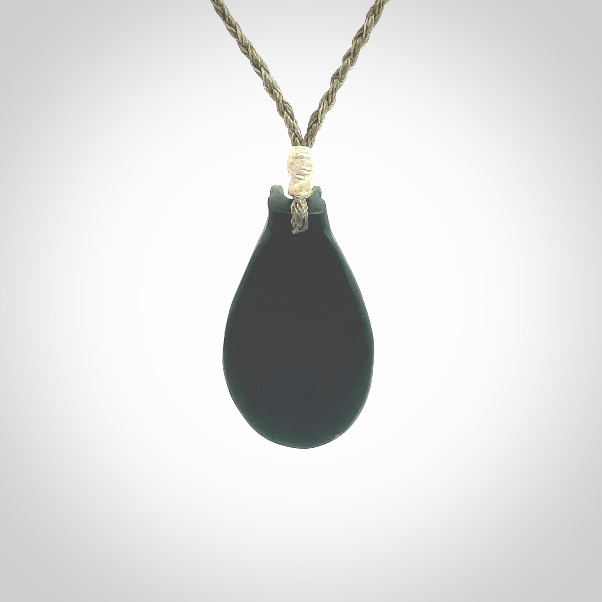 This is a unique contemporary drop pendant, hand carved from New Zealand Jade with Pearl insert. The cord is olive green and is length adjustable. This is delivered to you with Express Courier. Hand carved Pounamu, Jade necklace with adjustable cord from Ana Krakosky.