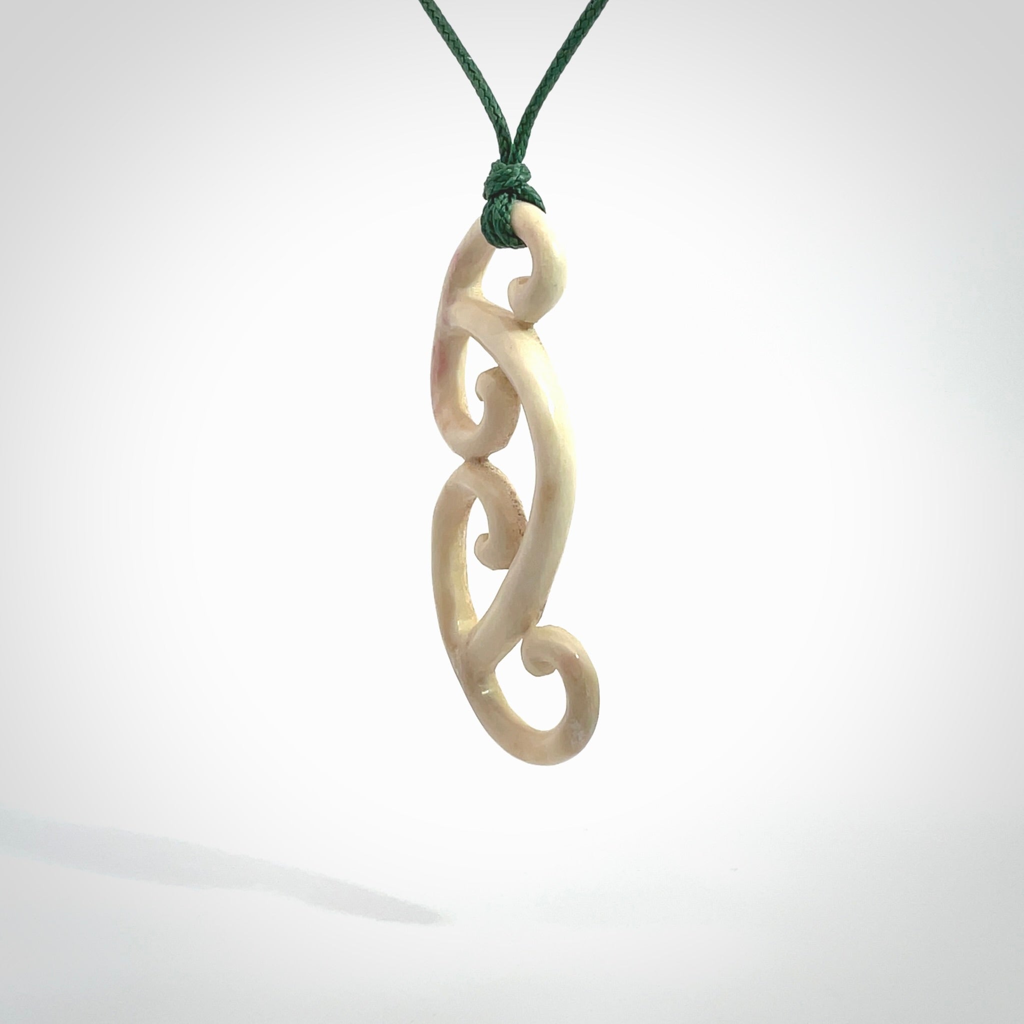 This is a wonderful, gently curved piece with a multiple koru design. We've carved this from deer antler and bind it on adjustable cords of various colours. Order yours now on NZ Pacific at www.nzpacific.com