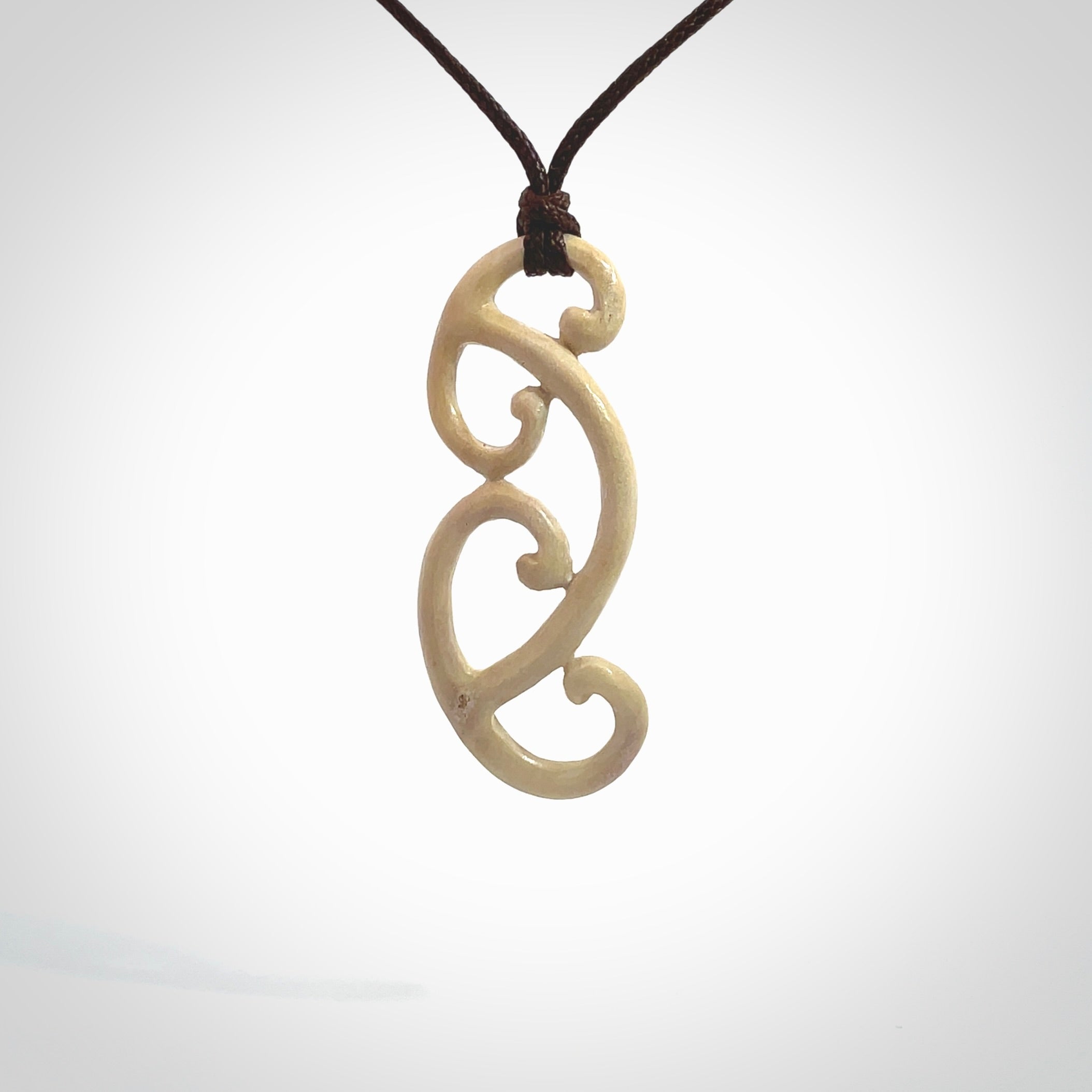 This is a wonderful, gently curved piece with a multiple koru design. We've carved this from deer antler and bind it on adjustable cords of various colours. Order yours now on NZ Pacific at www.nzpacific.com