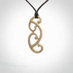 This is a wonderful, gently curved piece with a multiple koru design. We've carved this from deer antler and bind it on adjustable cords of various colours. Order yours now on NZ Pacific at www.nzpacific.com