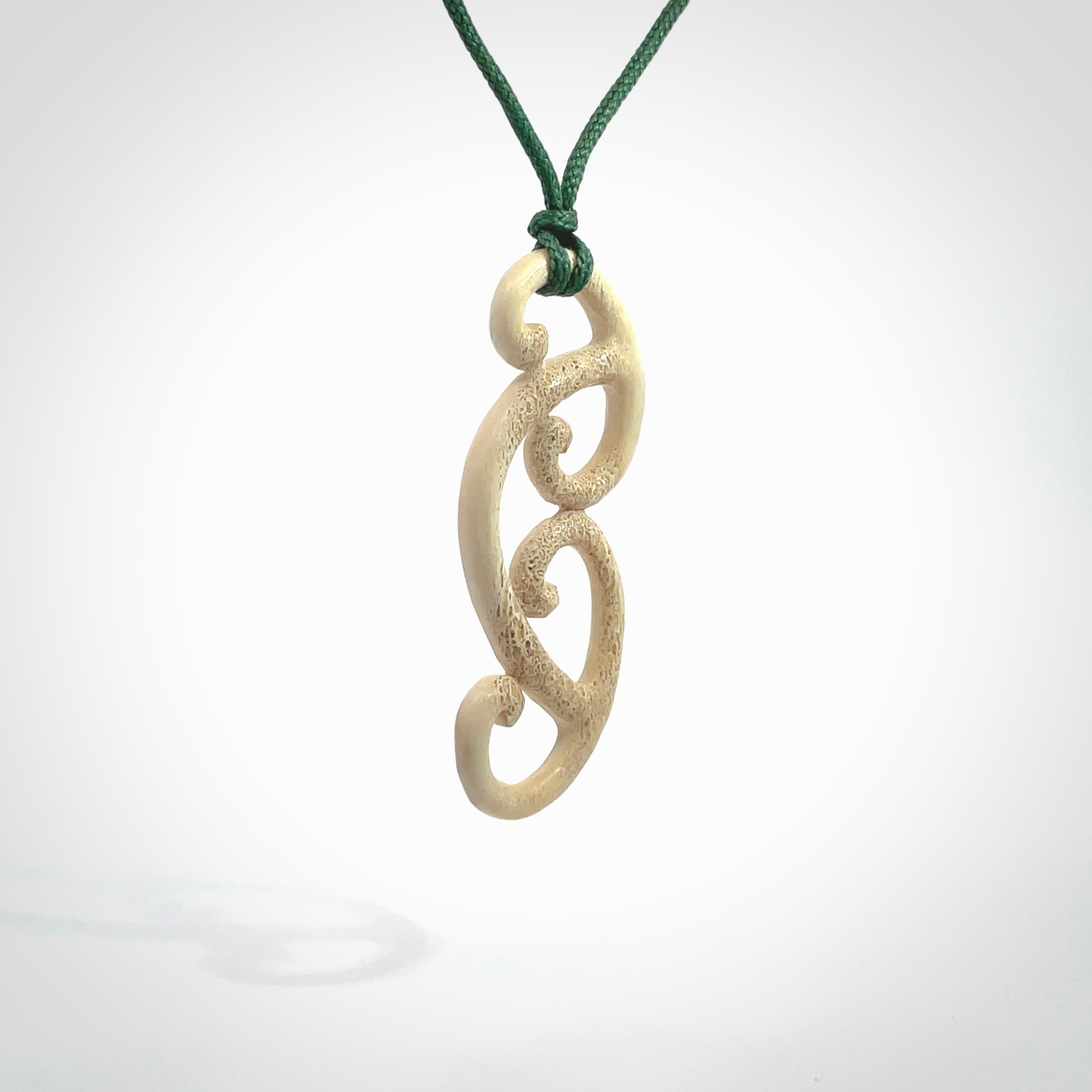 This is a wonderful, gently curved piece with a multiple koru design. We've carved this from deer antler and bind it on adjustable cords of various colours. Order yours now on NZ Pacific at www.nzpacific.com