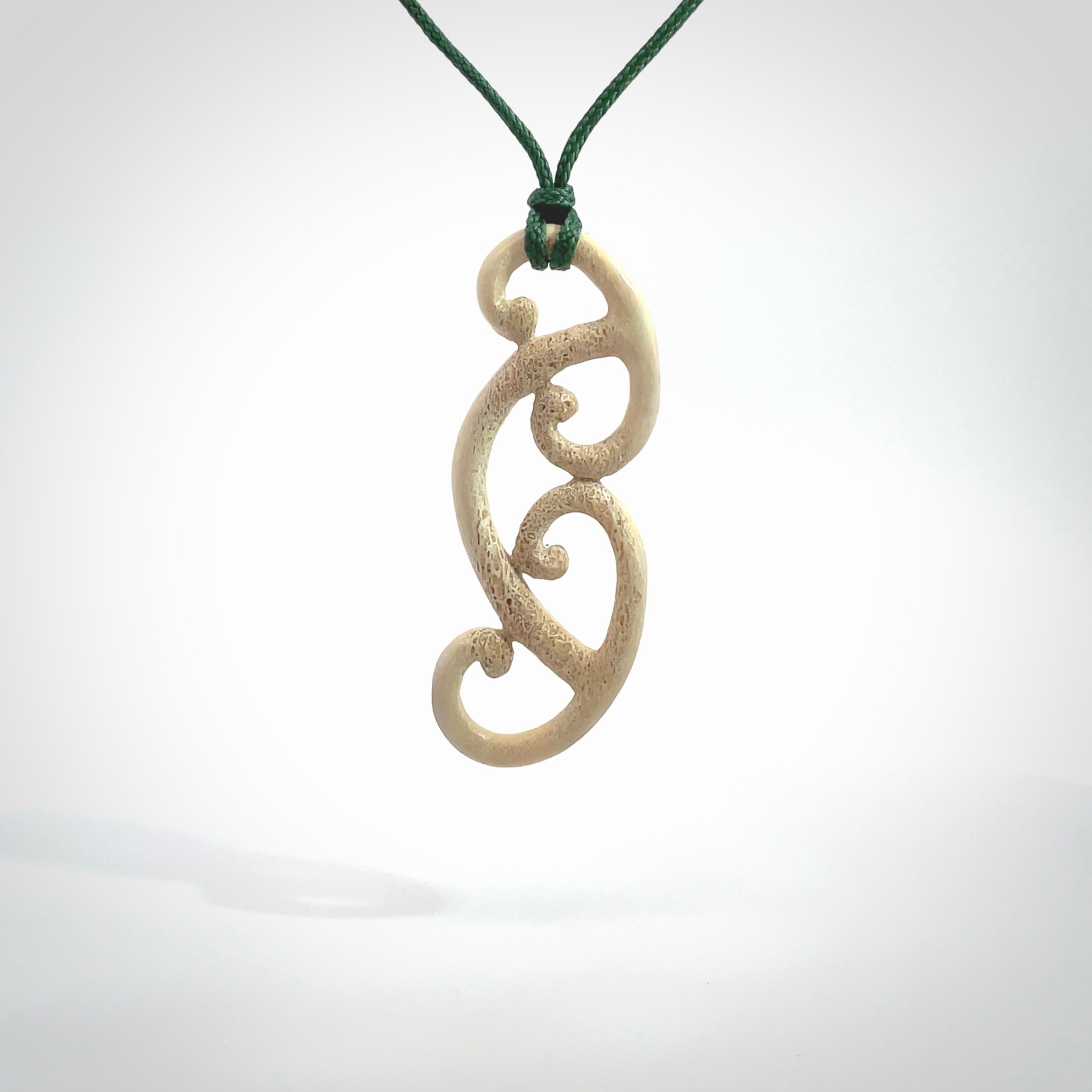 This is a wonderful, gently curved piece with a multiple koru design. We've carved this from deer antler and bind it on adjustable cords of various colours. Order yours now on NZ Pacific at www.nzpacific.com