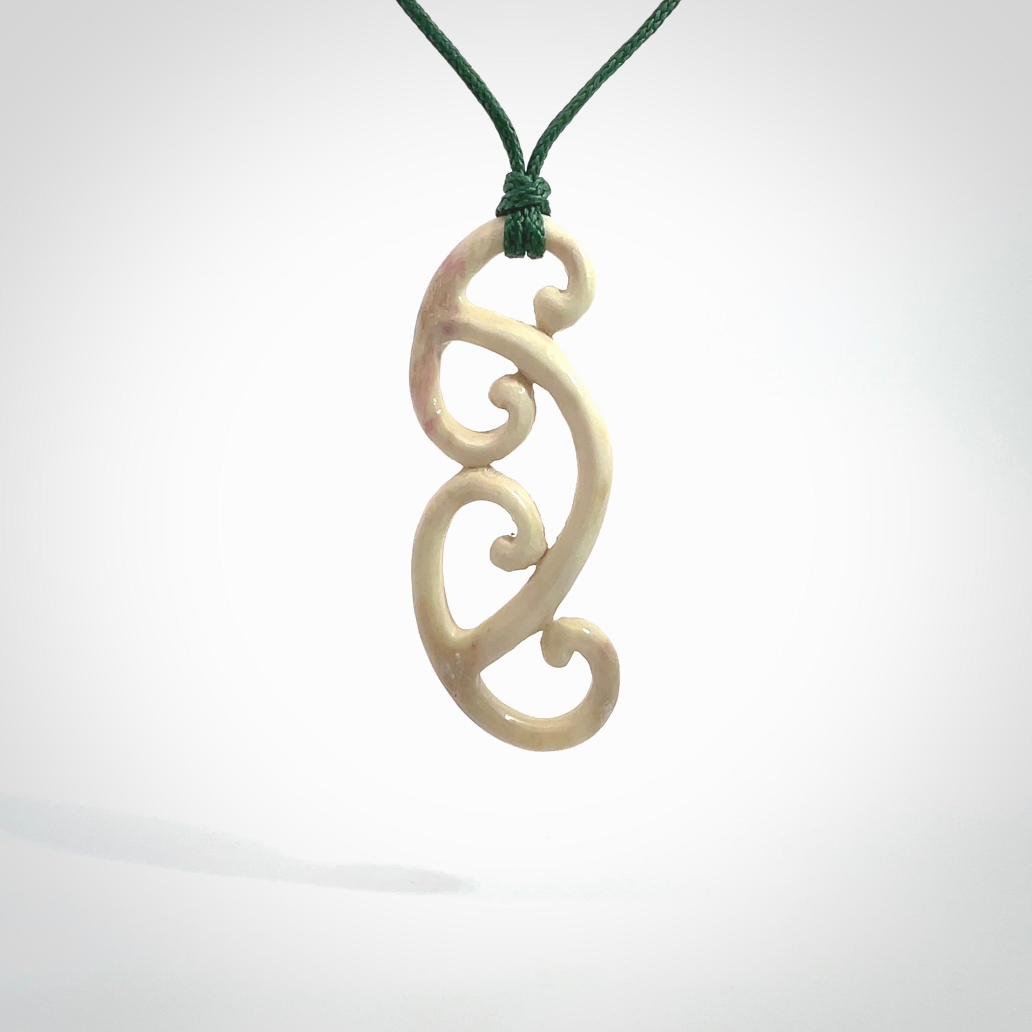 This is a wonderful, gently curved piece with a multiple koru design. We've carved this from deer antler and bind it on adjustable cords of various colours. Order yours now on NZ Pacific at www.nzpacific.com