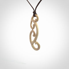 This is a wonderful, gently curved piece with a multiple koru design. We've carved this from deer antler and bind it on adjustable cords of various colours. Order yours now on NZ Pacific at www.nzpacific.com