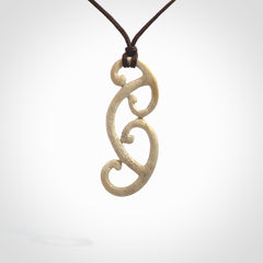 This is a wonderful, gently curved piece with a multiple koru design. We've carved this from deer antler and bind it on adjustable cords of various colours. Order yours now on NZ Pacific at www.nzpacific.com