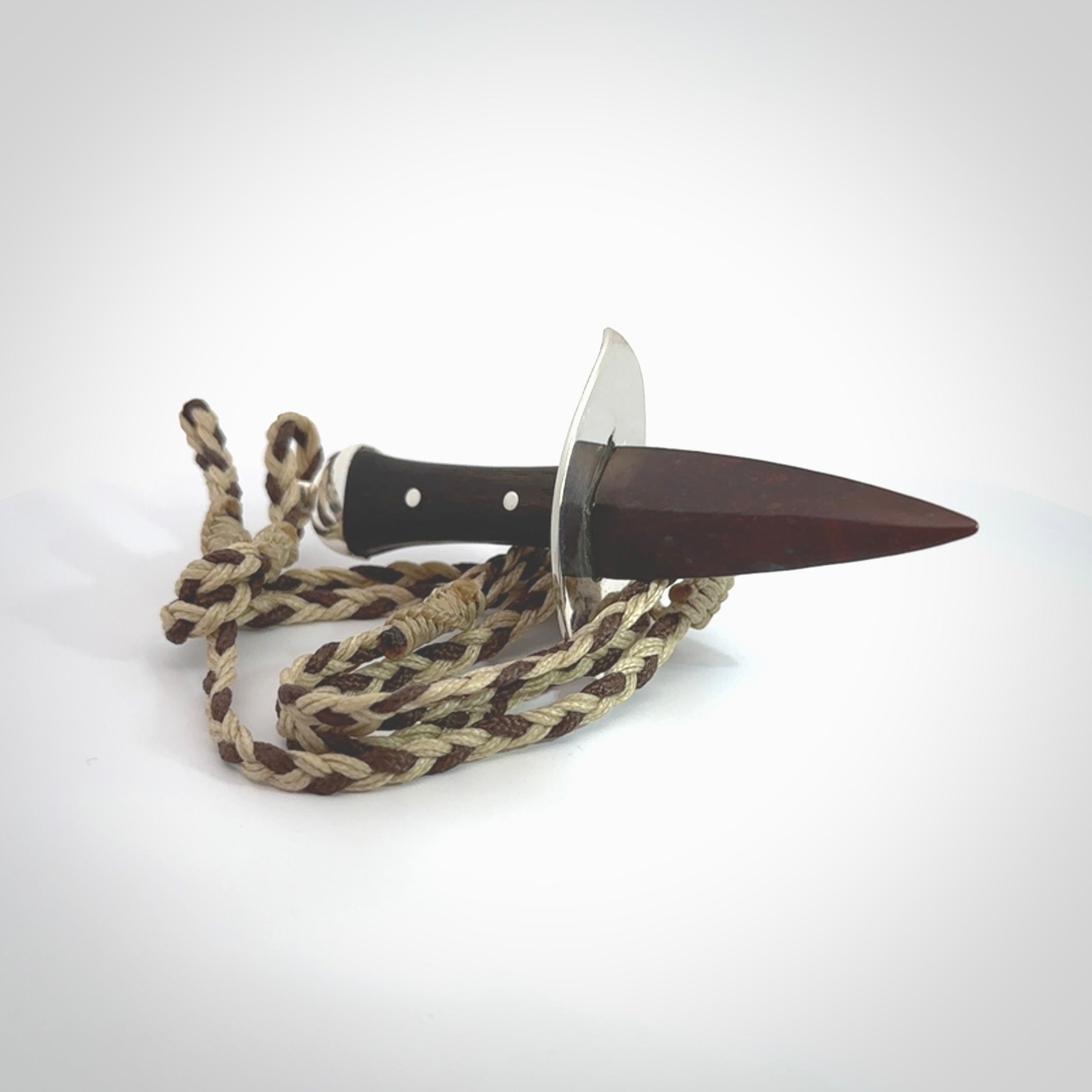 A striking hand carved knife pendant. These are carved with a Red Jasper Stone head and a hardwood handle. The cords are hand plaited in our waxed polyester which is robust, strong and durable. We ship these worldwide with express courier.