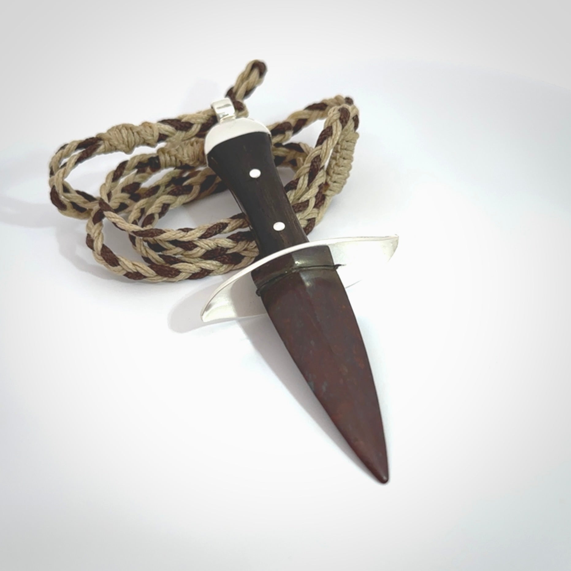 A striking hand carved knife pendant. These are carved with a Red Jasper Stone head and a hardwood handle. The cords are hand plaited in our waxed polyester which is robust, strong and durable. We ship these worldwide with express courier.