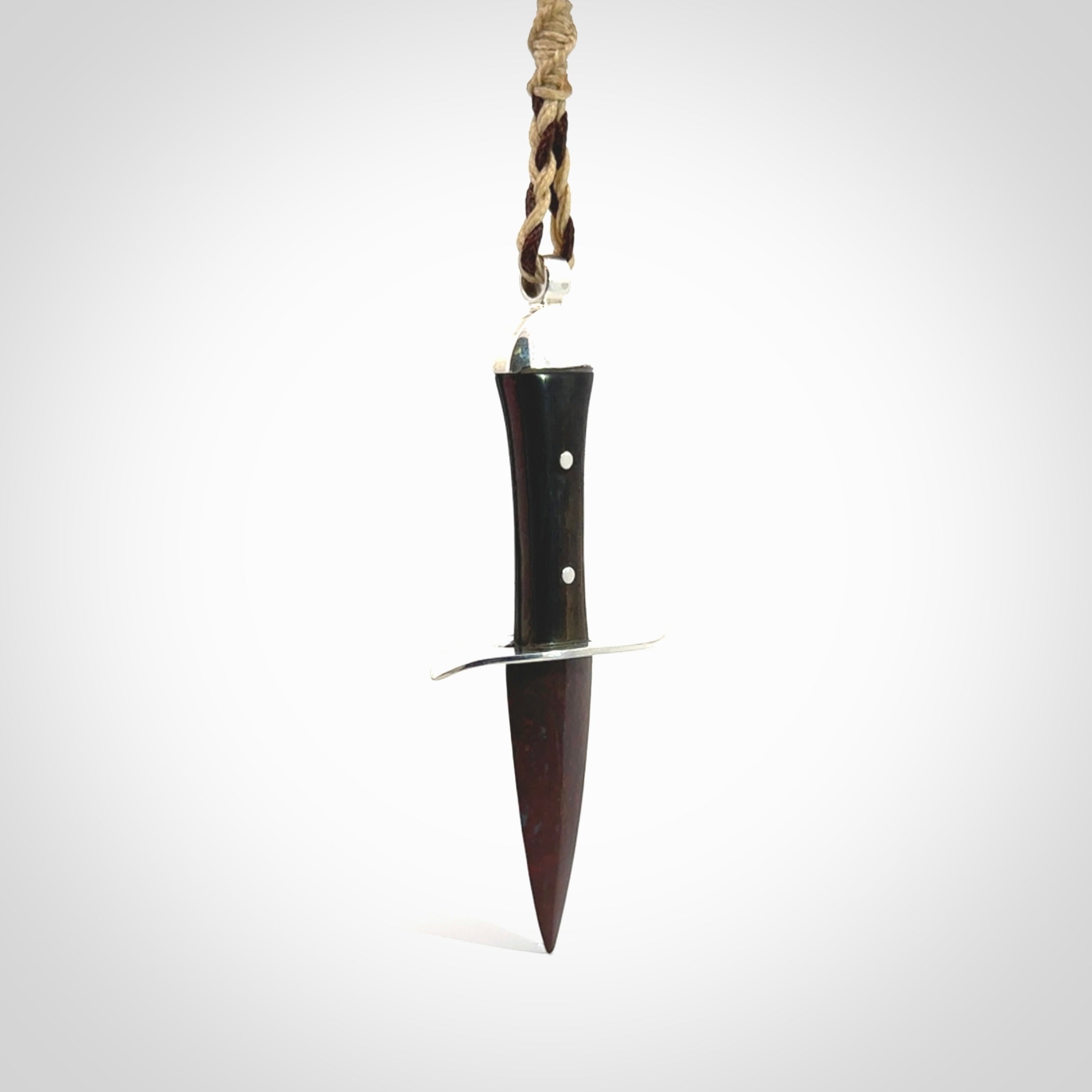 A striking hand carved knife pendant. These are carved with a Red Jasper Stone head and a hardwood handle. The cords are hand plaited in our waxed polyester which is robust, strong and durable. We ship these worldwide with express courier.