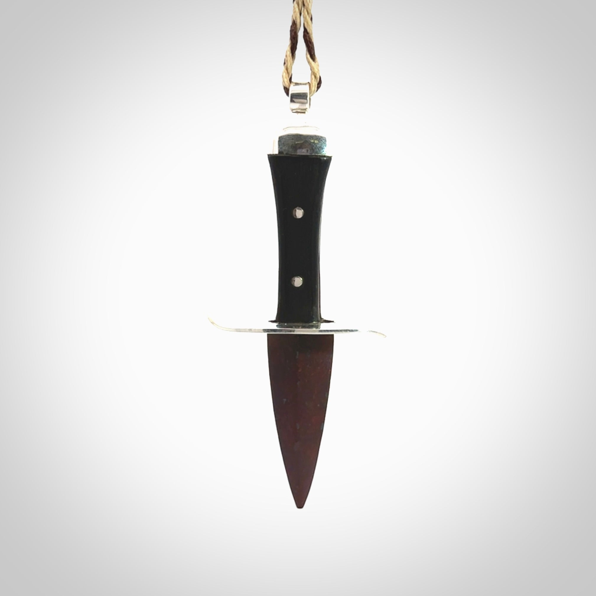 A striking hand carved knife pendant. These are carved with a Red Jasper Stone head and a hardwood handle. The cords are hand plaited in our waxed polyester which is robust, strong and durable. We ship these worldwide with express courier.