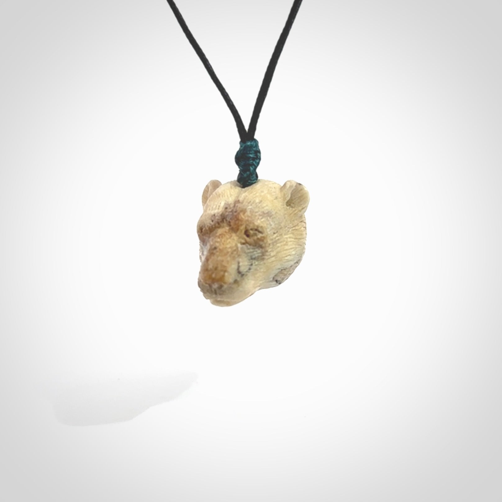 Hand carved deer antler polar bear pendant. Hand carved by NZ Pacific. Free postage worldwide. Hand made polar bear head necklace from deer antler. Animal themed necklace for men and women.