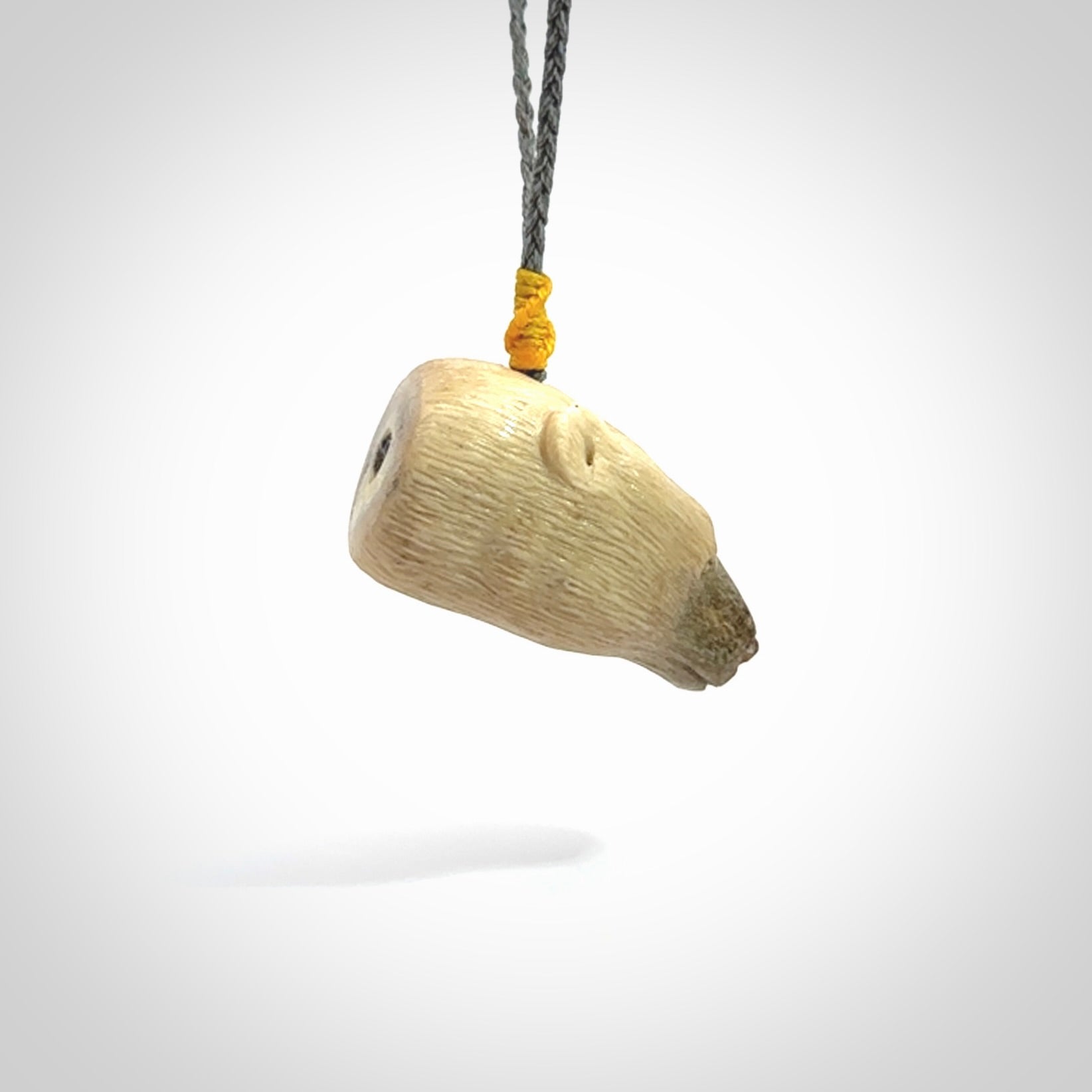 Hand carved deer antler polar bear pendant. Hand carved by NZ Pacific. Free postage worldwide. Hand made polar bear head necklace from deer antler. Animal themed necklace for men and women.