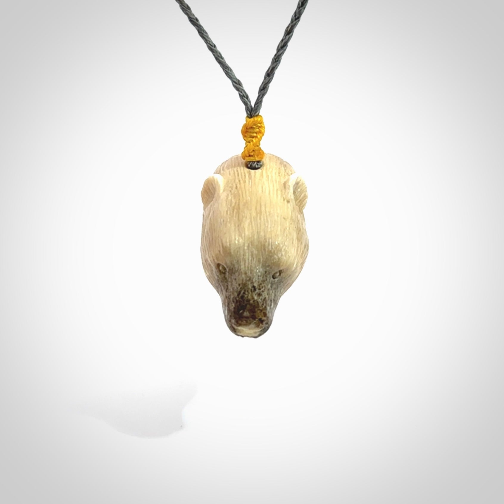 Hand carved deer antler polar bear pendant. Hand carved by NZ Pacific. Free postage worldwide. Hand made polar bear head necklace from deer antler. Animal themed necklace for men and women.