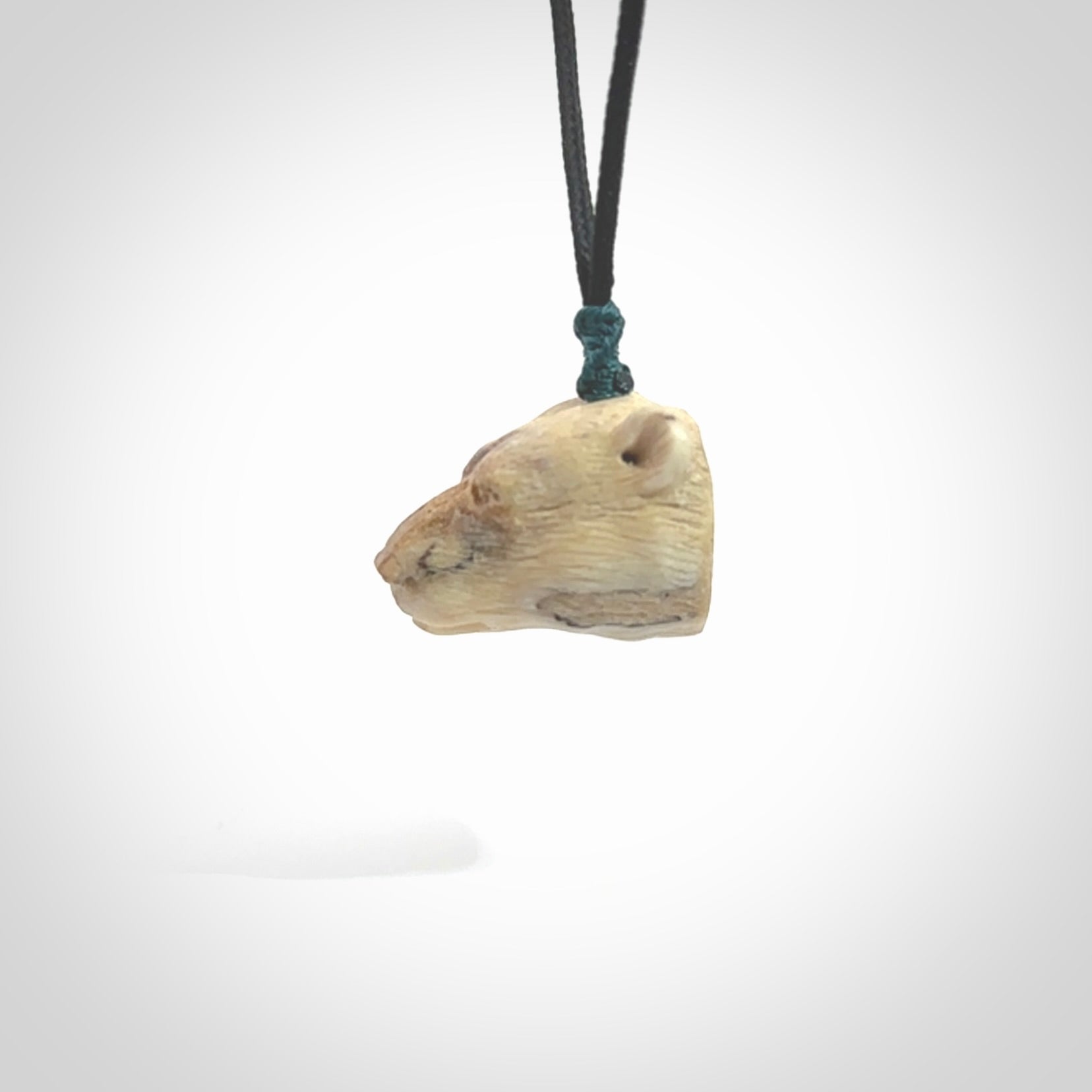 Hand carved deer antler polar bear pendant. Hand carved by NZ Pacific. Free postage worldwide. Hand made polar bear head necklace from deer antler. Animal themed necklace for men and women.