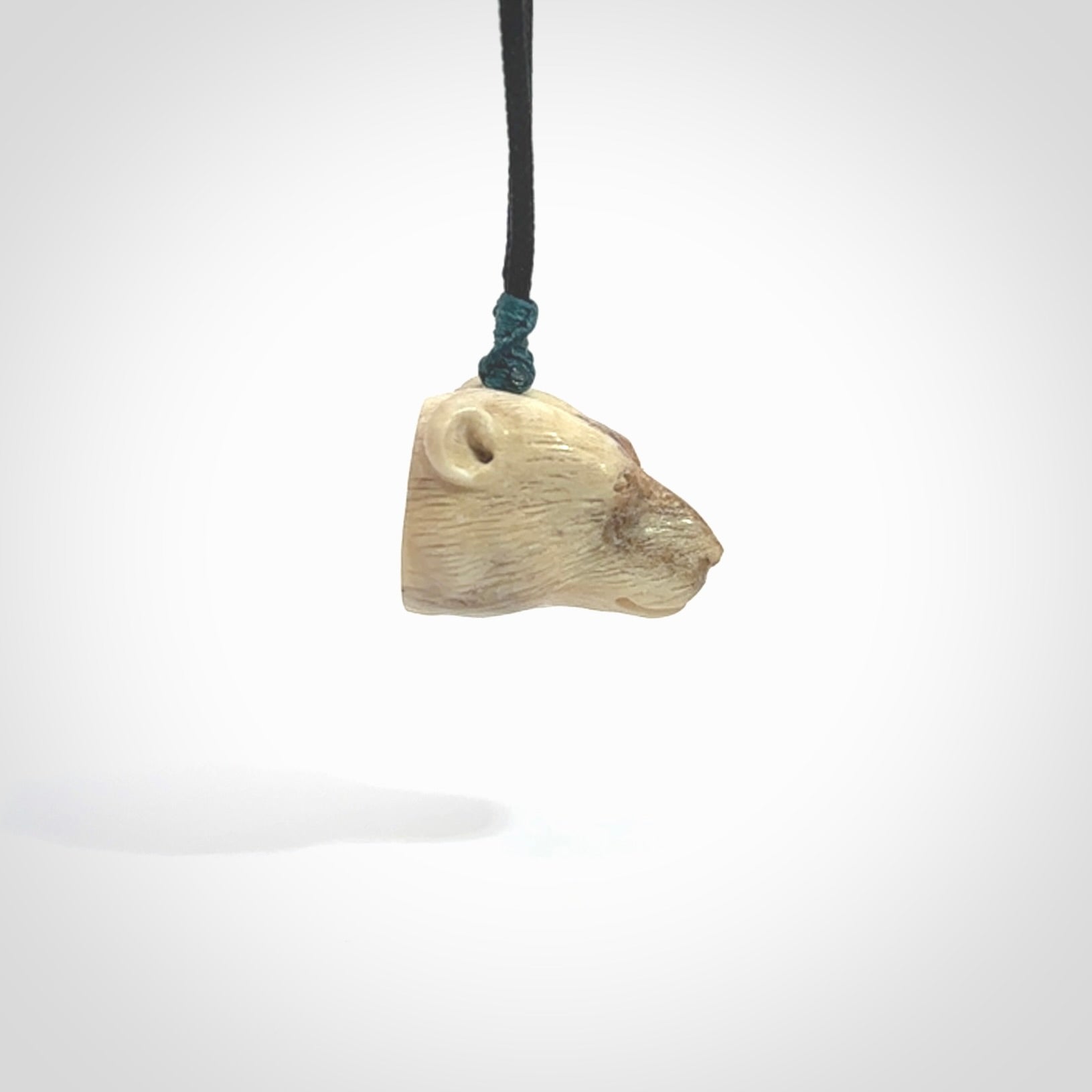 Hand carved deer antler polar bear pendant. Hand carved by NZ Pacific. Free postage worldwide. Hand made polar bear head necklace from deer antler. Animal themed necklace for men and women.