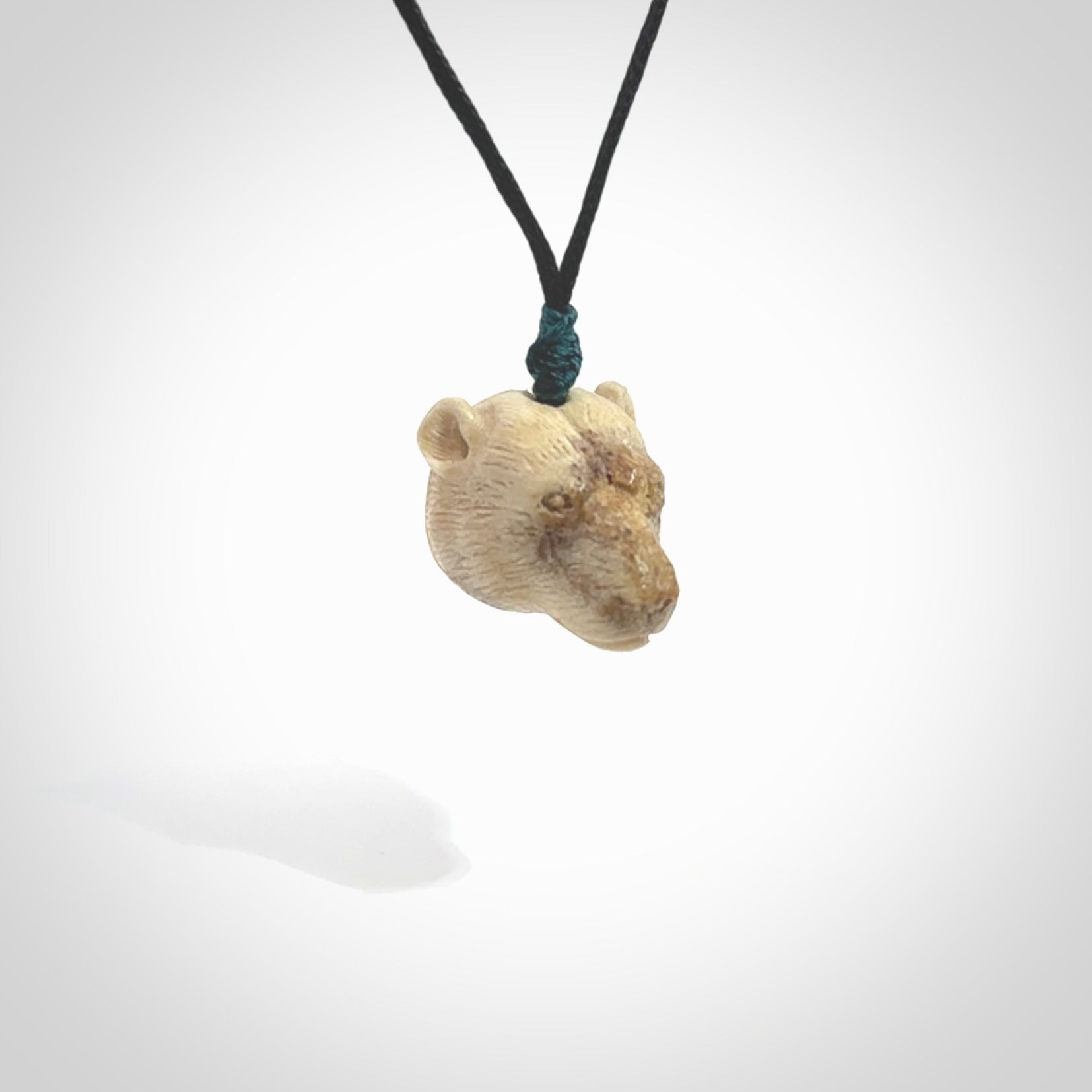 Hand carved deer antler polar bear pendant. Hand carved by NZ Pacific. Free postage worldwide. Hand made polar bear head necklace from deer antler. Animal themed necklace for men and women.