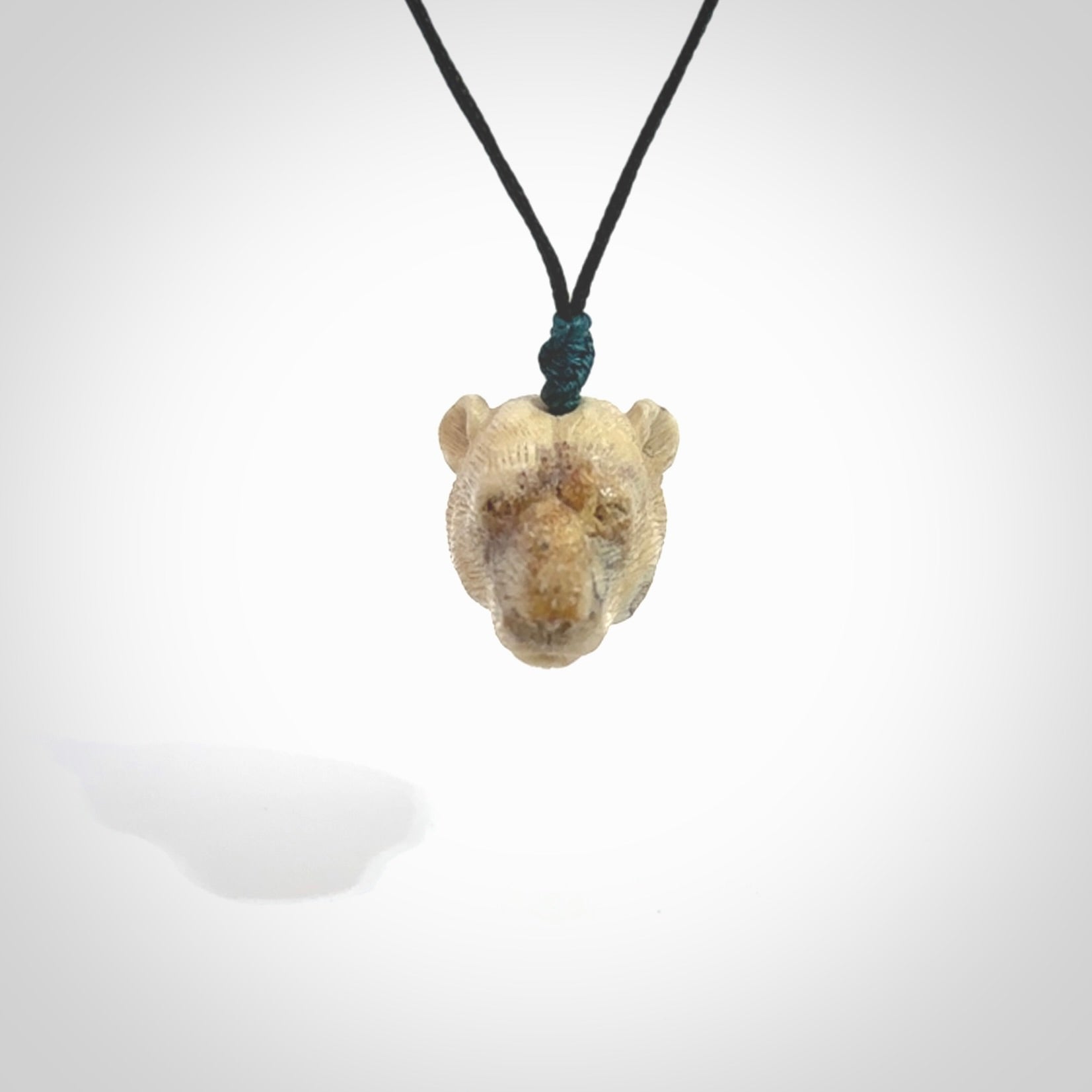 Hand carved deer antler polar bear pendant. Hand carved by NZ Pacific. Free postage worldwide. Hand made polar bear head necklace from deer antler. Animal themed necklace for men and women.