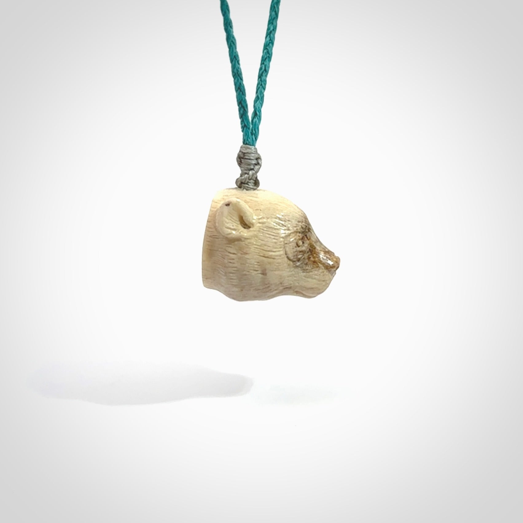 Hand carved deer antler polar bear pendant. Hand carved by NZ Pacific. Free postage worldwide. Hand made polar bear head necklace from deer antler. Animal themed necklace for men and women.