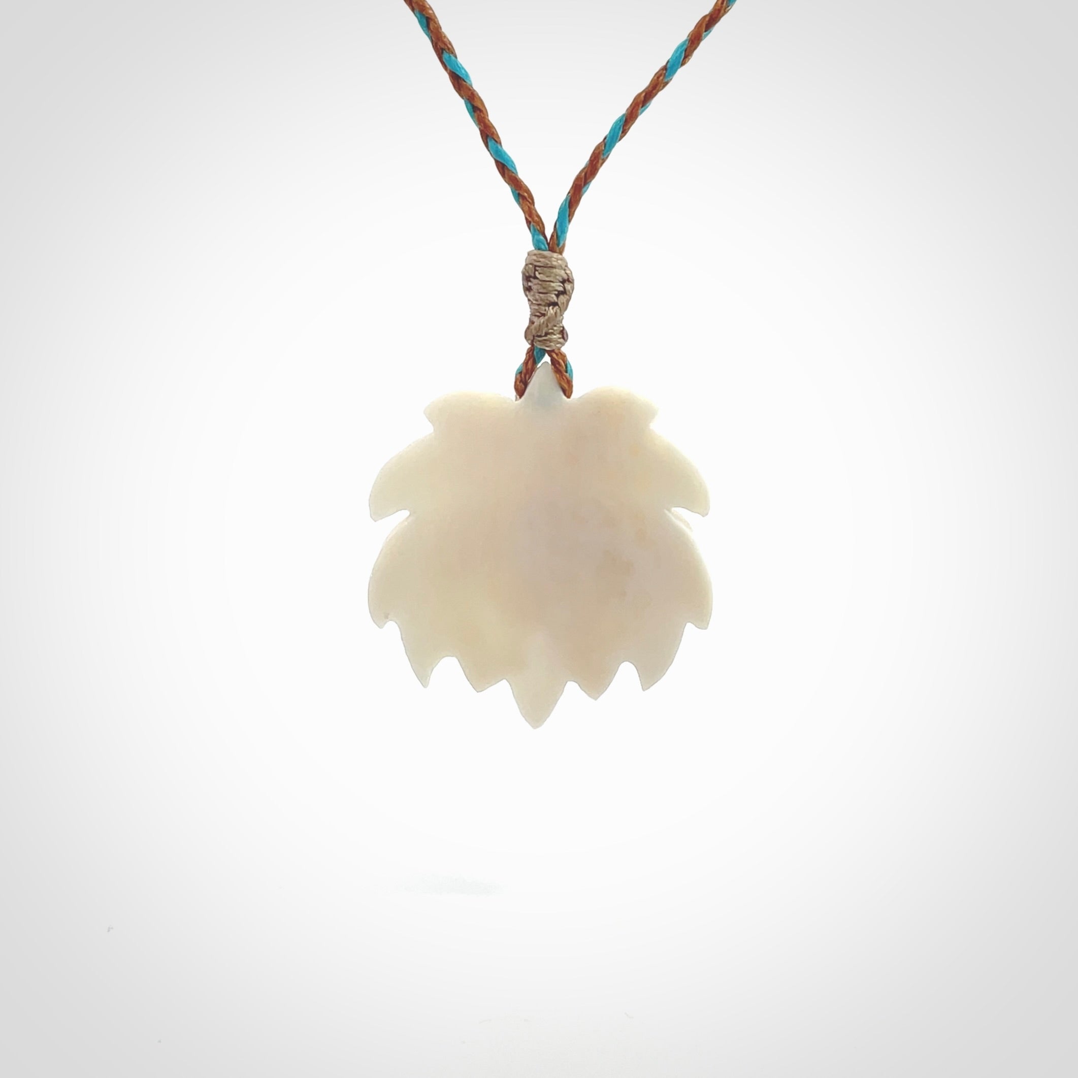 This is a hand carved lotus flower pendant. It is made from bone. This is a medium sized necklace and is a very unique pendant and is a wonderful necklace to wear. Hand carved bone lotus flower pendant with adjustable cord.