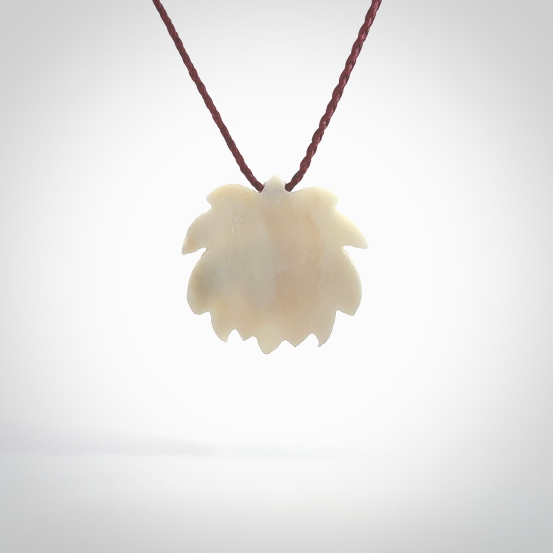 This is a hand carved lotus flower pendant. It is made from bone. This is a medium sized necklace and is a very unique pendant and is a wonderful necklace to wear. Hand carved bone lotus flower pendant with adjustable cord.