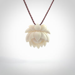 This is a hand carved lotus flower pendant. It is made from bone. This is a medium sized necklace and is a very unique pendant and is a wonderful necklace to wear. Hand carved bone lotus flower pendant with adjustable cord.