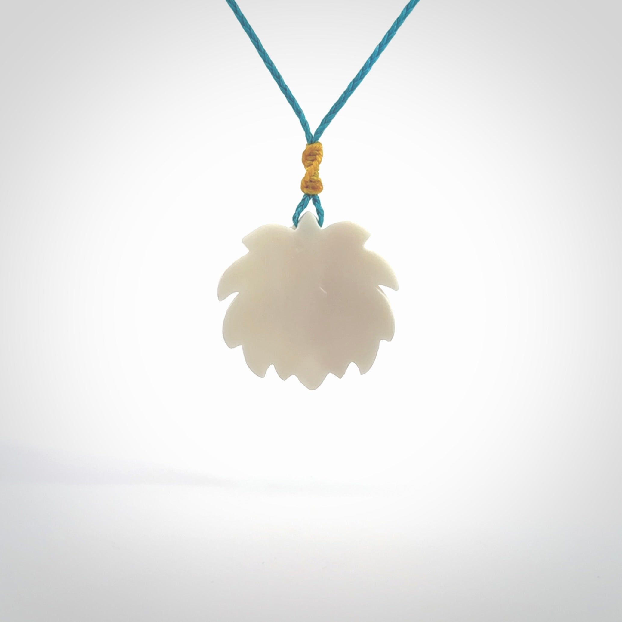 This is a hand carved lotus flower pendant. It is made from bone. This is a medium sized necklace and is a very unique pendant and is a wonderful necklace to wear. Hand carved bone lotus flower pendant with adjustable cord.