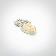 Hand made woolly mammoth tusk moon face necklace. Made by NZ Pacific and sale online only.