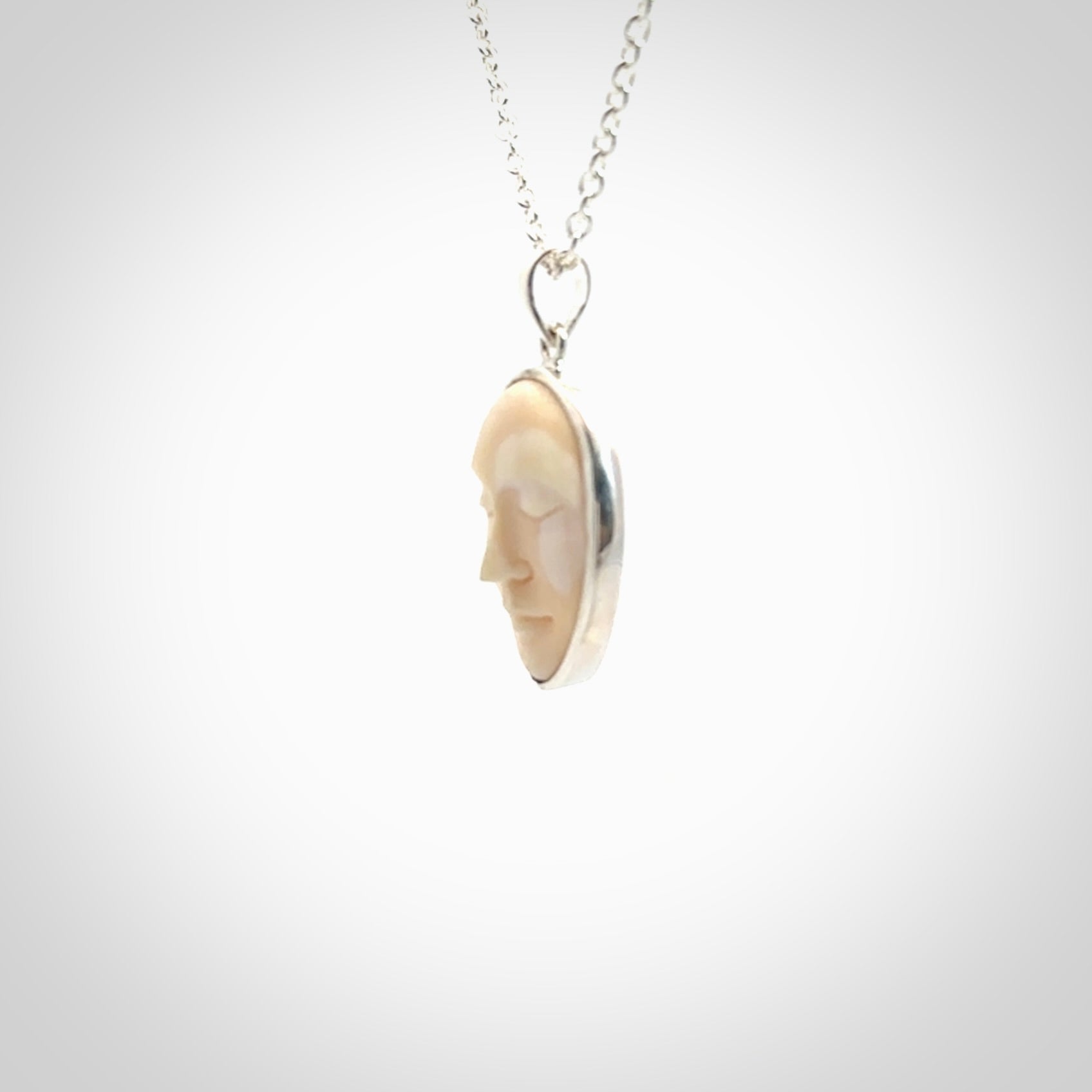 Hand made woolly mammoth tusk moon face necklace. Made by NZ Pacific and sale online only.