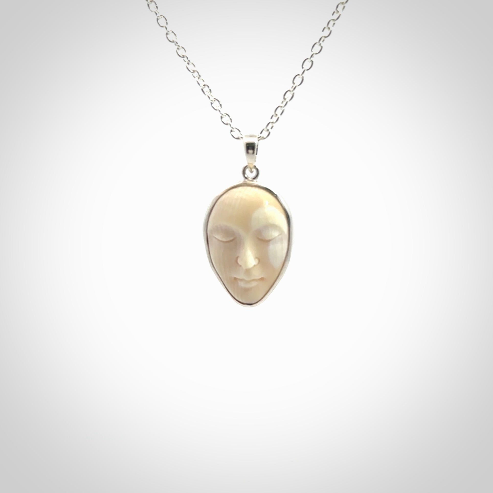 Hand made woolly mammoth tusk moon face necklace. Made by NZ Pacific and sale online only.